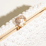 Elegant Pearl Clutch Bag – Designer - Inspired Evening Handbag with Gem Clasp & Gold Chain Description: - in Pearl White | Arvea Bags