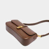 Éloise | Sleek Leather Baguette Bag – Detachable Strap & Gold - Tone Lock - in Brown | Arvea Bags