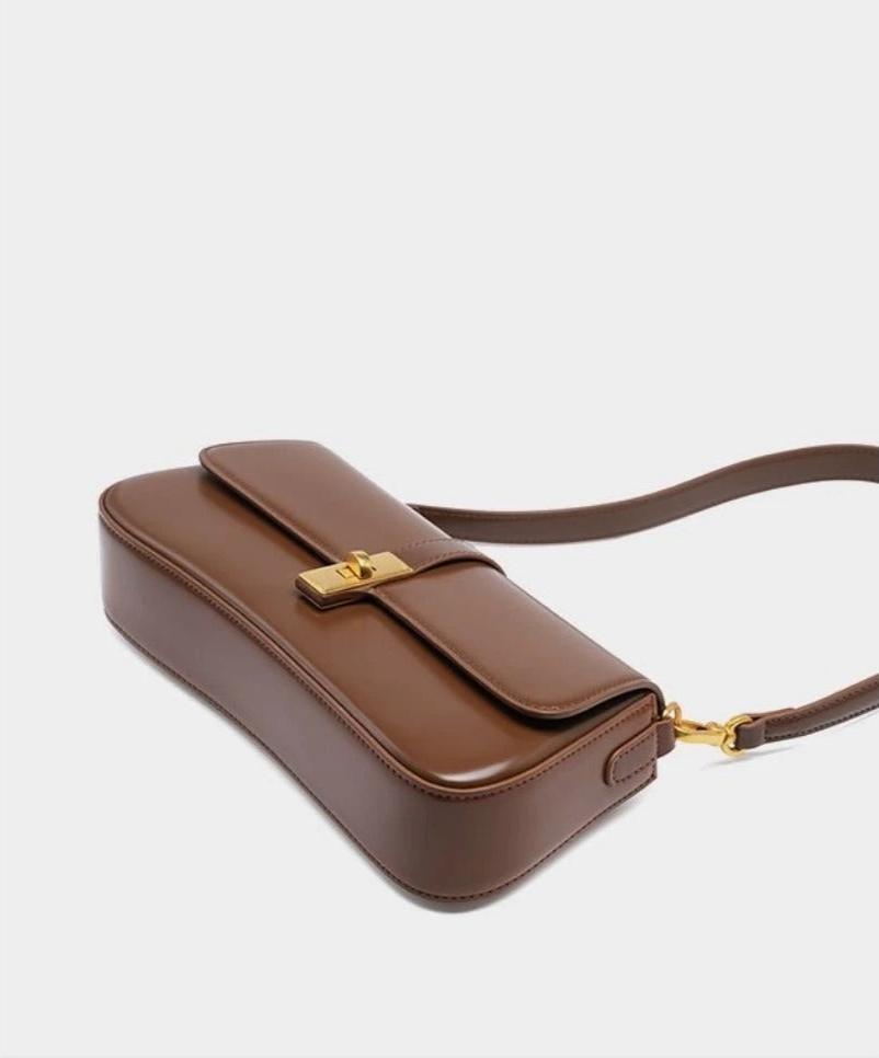 Éloise | Sleek Leather Baguette Bag – Detachable Strap & Gold - Tone Lock - in Brown | Arvea Bags