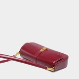 Éloise | Sleek Leather Baguette Bag – Detachable Strap & Gold - Tone Lock - in Burgundy | Arvea Bags