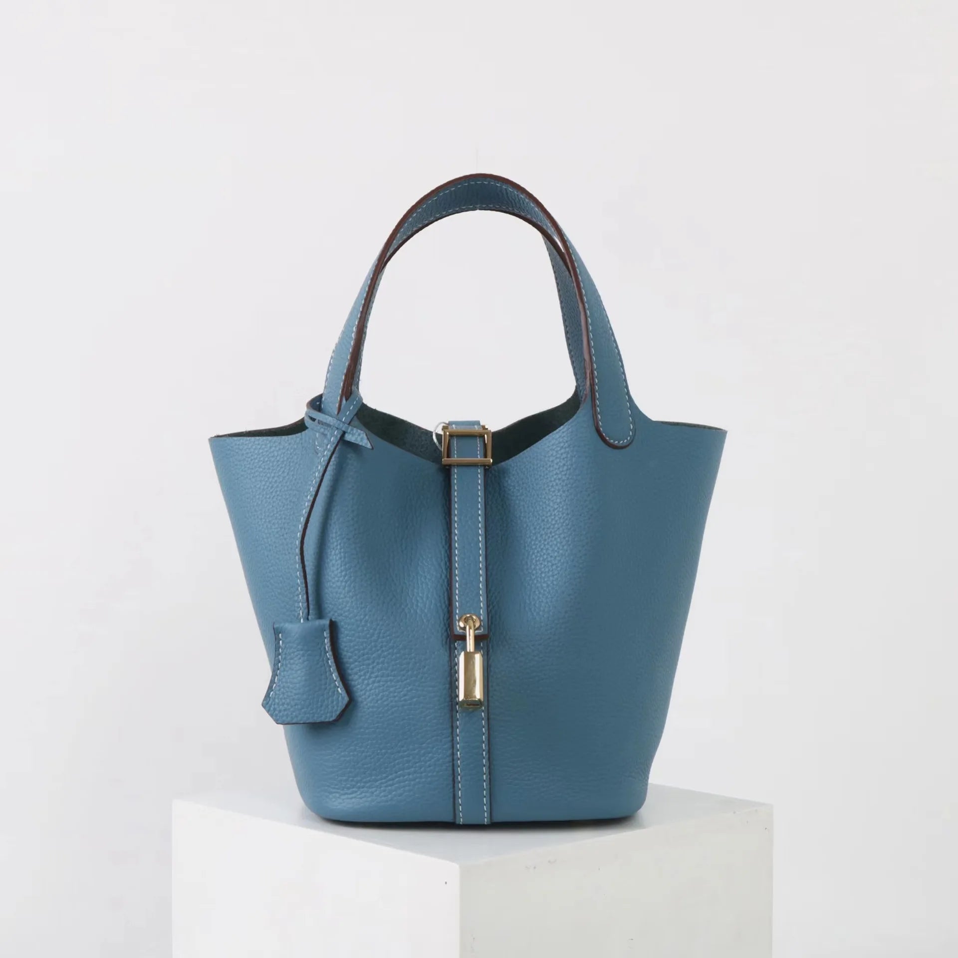 Minimalist Leather Bucket Bag – Small Structured Tote with Gold Padlock Detail - in Baby blue | Arvea Bags